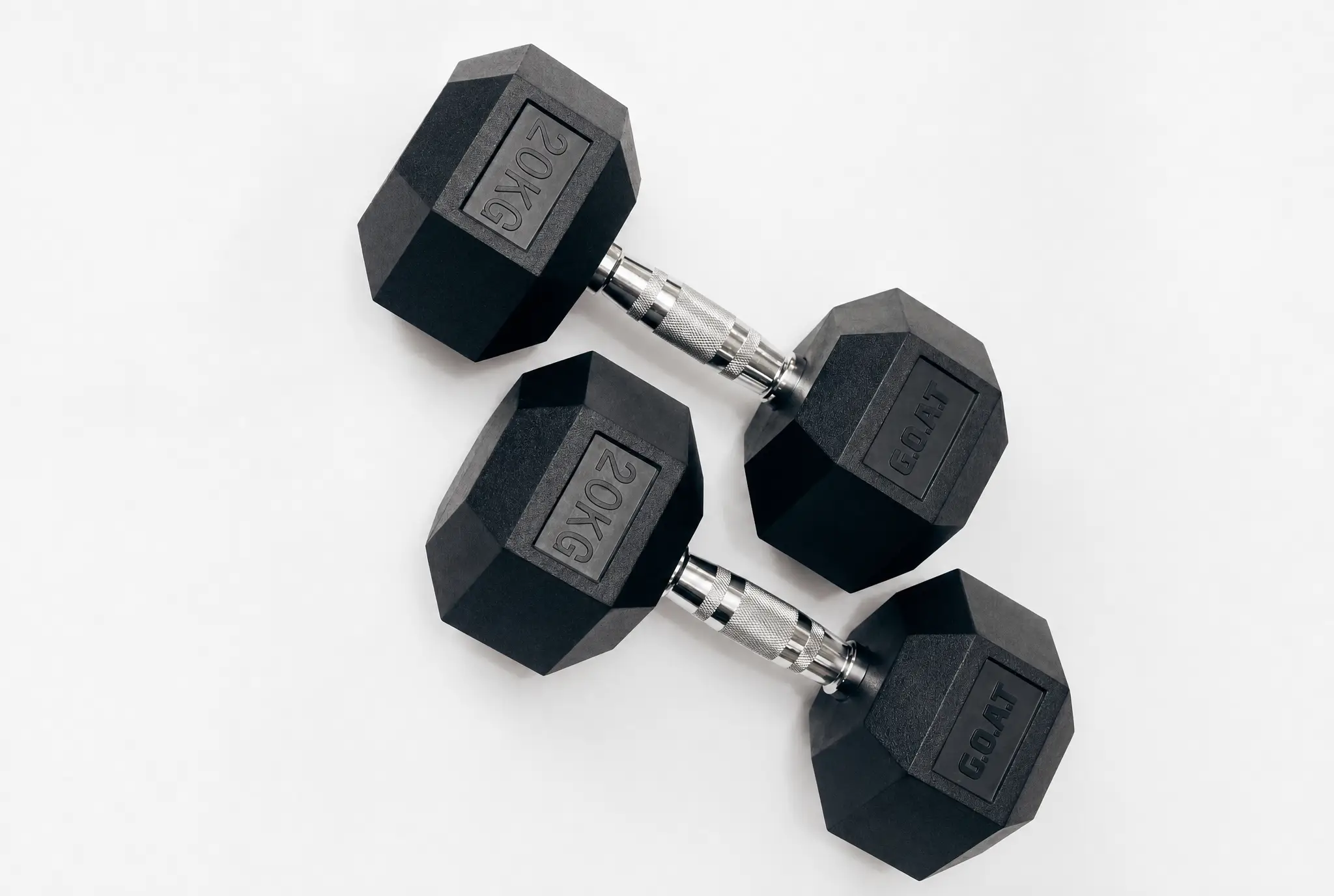 Heavy hex-head dumbbells racked under single-source side light.